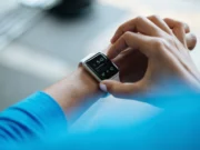 Whoop 5.0 Review 2026: Is the Subscription Worth It? Person clicking Apple Watch