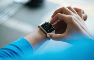 Whoop 5.0 Review 2026: Is the Subscription Worth It? Person clicking Apple Watch
